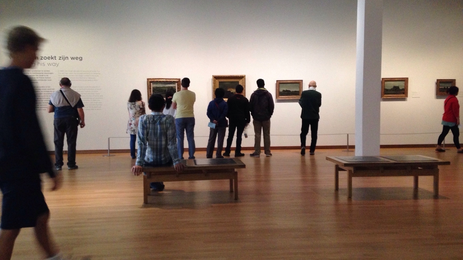 People are observing paintings in Van Gogh’s museum in Amsterdam.